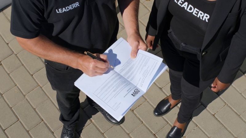 COC Certificate Cape Town - inspector and homeowner reviewing a compliance checklist outside a house